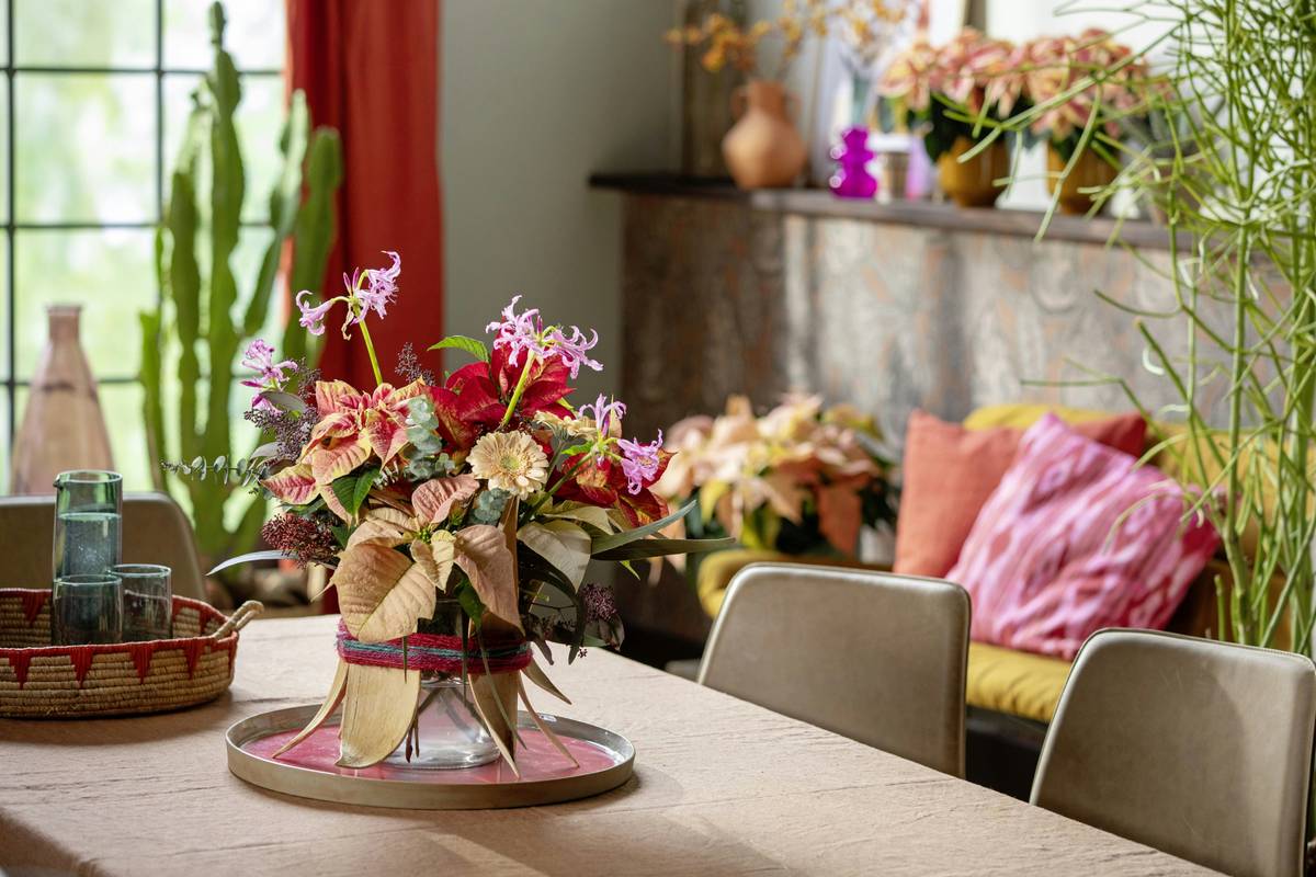 Elegant home made centerpiece using white candles, marble slab, and preserved ferns